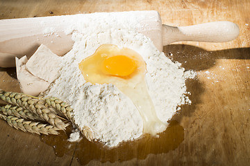 Image showing Pile of flour, rolling pin and wheat