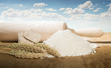 Image showing Rolling pin,flour and wheat ears.