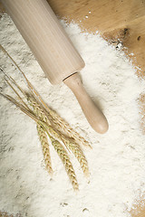Image showing Pile of flour, rolling pin and wheat