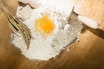 Image showing Pile of flour, rolling pin and wheat