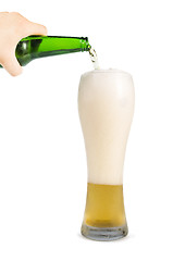 Image showing Hand holding bottle of beer and beer mug