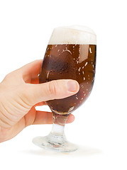 Image showing Hand holding bottle of beer and beer mug