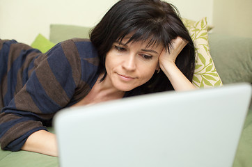 Image showing Woman with laptop on sofa