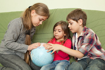 Image showing Kids looking at globe