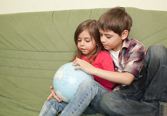 Image showing Kids looking at globe