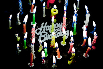 Image showing Candels on chocolate cake in the dark