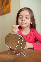 Image showing Applying lipstick