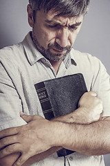 Image showing man holding a bible