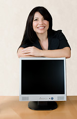 Image showing Woman leaning on lcd screen