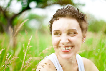 Image showing cute girl on green field 