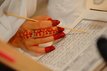 Image showing Bride reading Quran