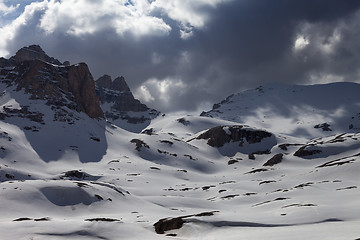 Image showing Snowy mountains in storm clouds