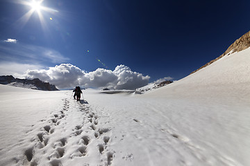 Image showing Two hikers on snow plateau.