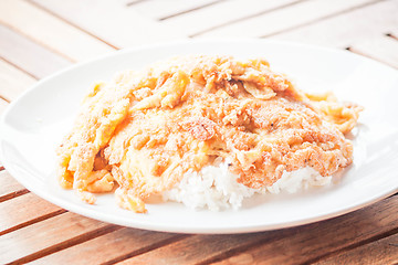 Image showing Plain egg omelet top on cooked rice