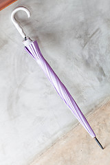 Image showing Violet uv protection umbrella on the floor