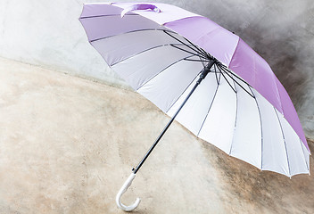Image showing Purple silver bronze uv protection umbrella on the floor