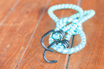 Image showing Light blue elastic rope with metal hooks 