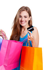 Image showing attractive young woman with colorful shopping bags isolated