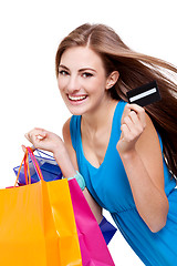 Image showing attractive young woman with colorful shopping bags isolated