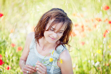 Image showing adult brunette woman smiling in summertime outdoor