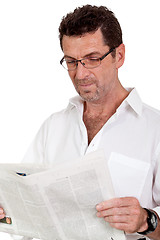 Image showing attractive adult businessman reading newspaper isolated