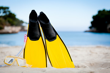 Image showing yellow fins and snorkelling mask on beach in summer