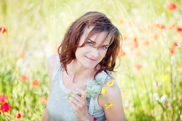 Image showing adult brunette woman smiling in summertime outdoor