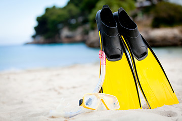 Image showing yellow fins and snorkelling mask on beach in summer
