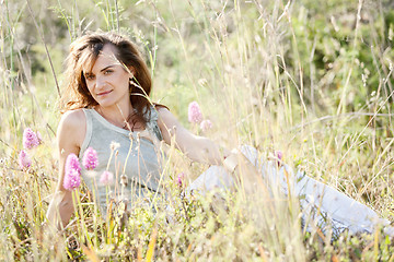 Image showing adult brunette woman smiling in summertime outdoor