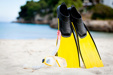 Image showing yellow fins and snorkelling mask on beach in summer