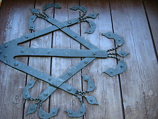 Image showing beautiful wooden gate with iron patterns