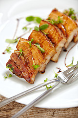 Image showing grilled pork on white plate, restaurant portion