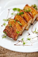 Image showing grilled pork on white plate, restaurant portion