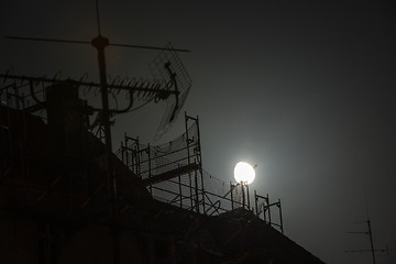 Image showing Full moon over the roofs
