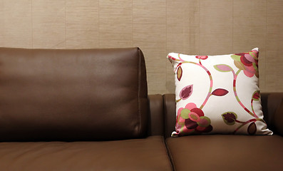 Image showing Floral pillow on a brown leather couch - home interiors