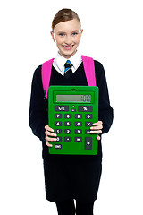 Image showing School girl holding large green calculator