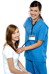 Image showing Friendly doctor examining her patient