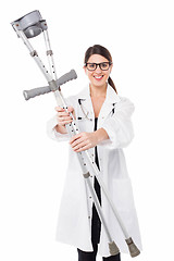 Image showing Female doctor handing over crutches