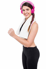 Image showing Girl enjoying music while working out