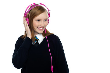 Image showing Pretty schoolgirl enjoying music