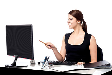 Image showing Female assistant at her work desk