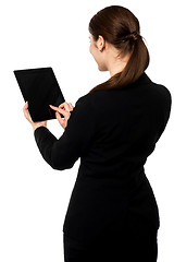 Image showing Business executive operating touch pad