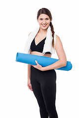 Image showing Pretty gym woman holding blue mat