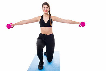 Image showing Female trainer exercising with dumbbells