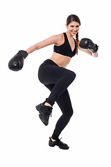 Image showing Pretty young boxer woman in action