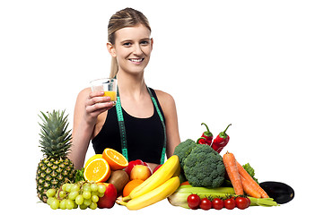 Image showing Pretty girl holding glass of fresh juice