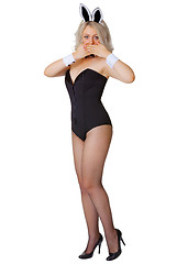 Image showing Beautiful young girl in a bunny suit coyly covers her mouth