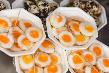 Image showing Scrambled quail eggs and boiled eggs at market