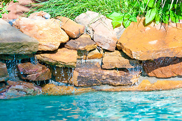 Image showing waterfall falling in a blue swimming pool