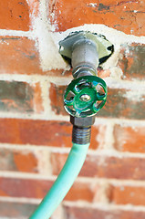Image showing A water faucet of a suburban home.